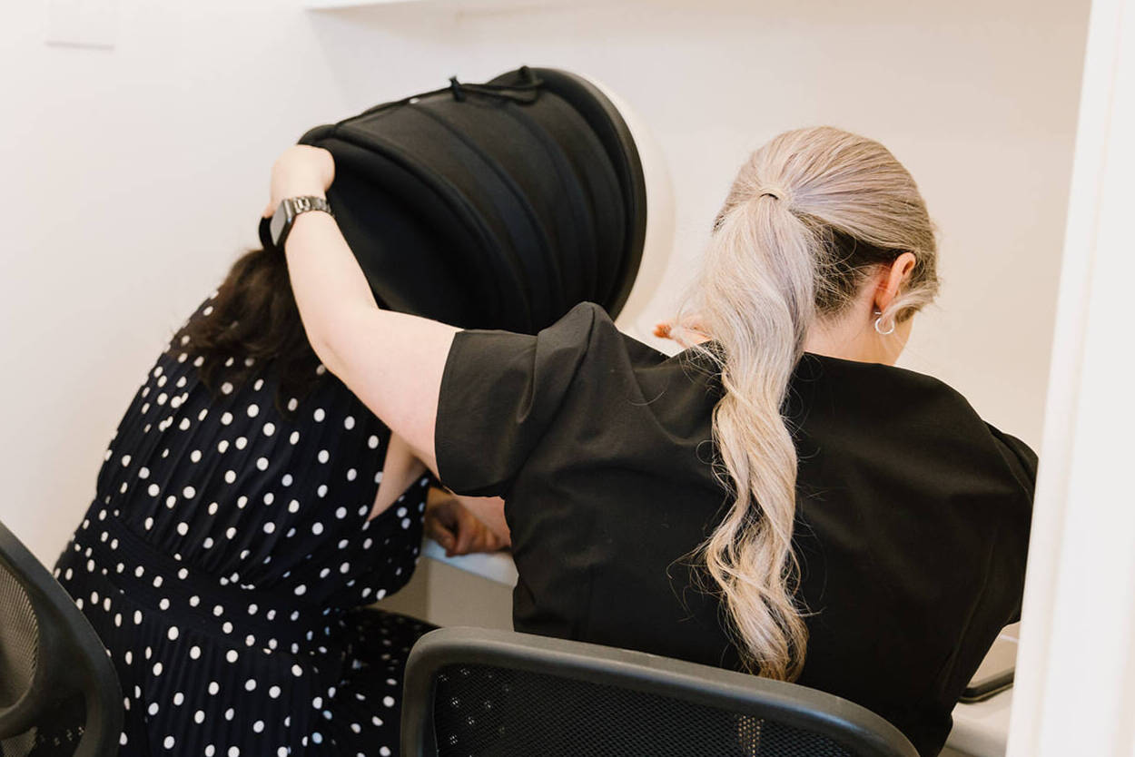 A dermal therapist working one-on-one with a client at The Skin Bar and Lounge